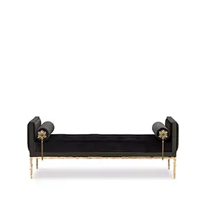 Elegant Privê Daybed with black velvet upholstery, sculptural golden details, and cylindrical pillows at the ends.