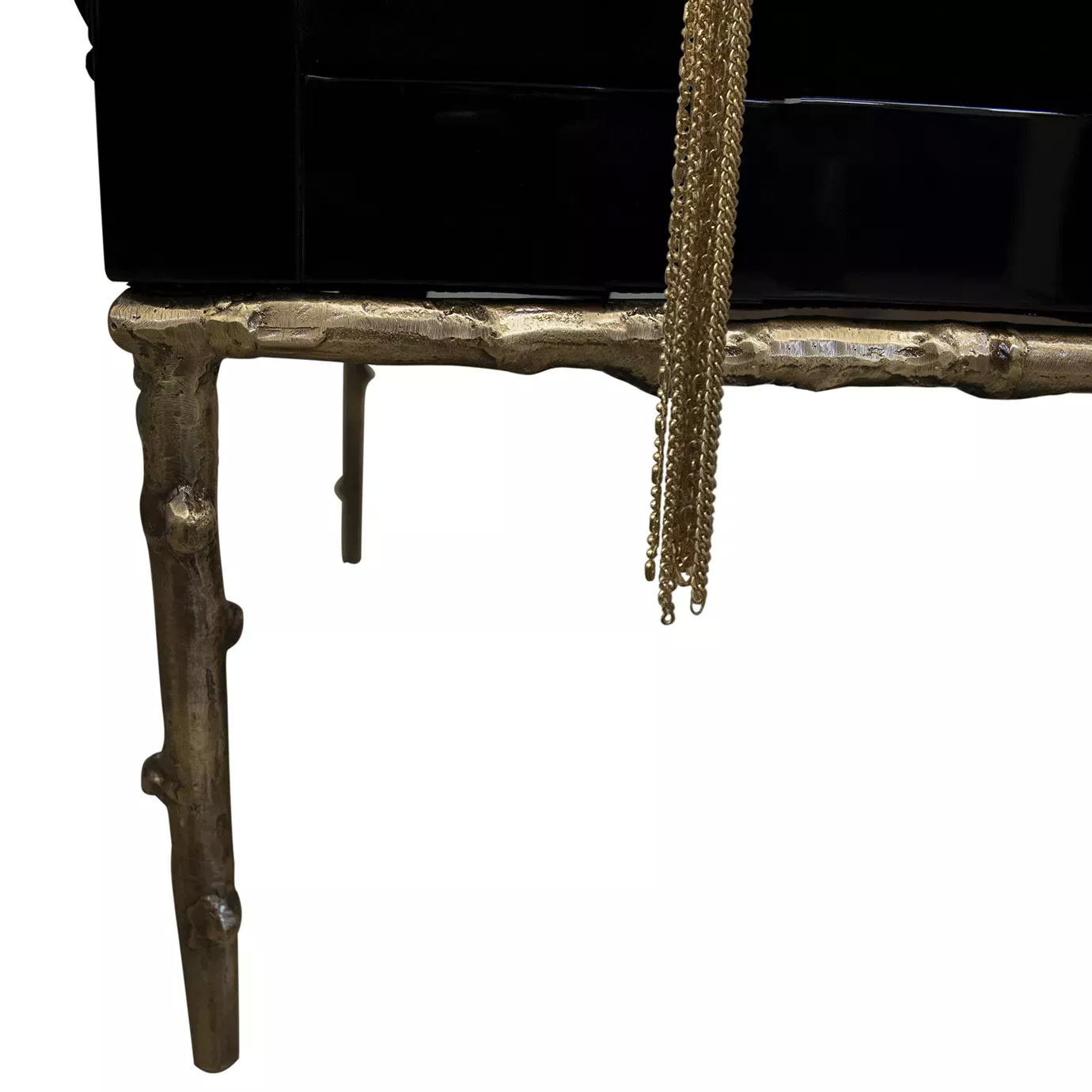 Elegant close-up of the sculptural golden base with natural texture of the Privê Daybed and tassel detail.