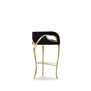 Side perspective of the glamourous Chandra Bar Stool, distinguished for its three legs, featuring a golden structure and black upholstery.