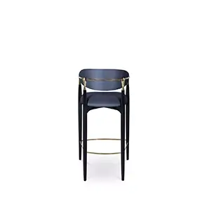 Nahéma Bar Stool seen from behind, showcasing its black frame and golden accents, with a focus on the hand-shaped details on the backrest of the chair, complemented by elegant dark blue velvet upholstery.