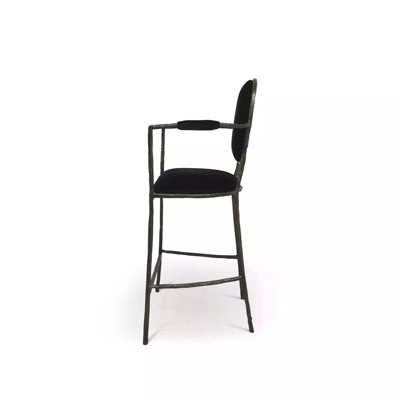 Side view of the Enchanted Bar Stool, showcasing its aged brass frame resembling branches, combining with the luxurious black upholstery.