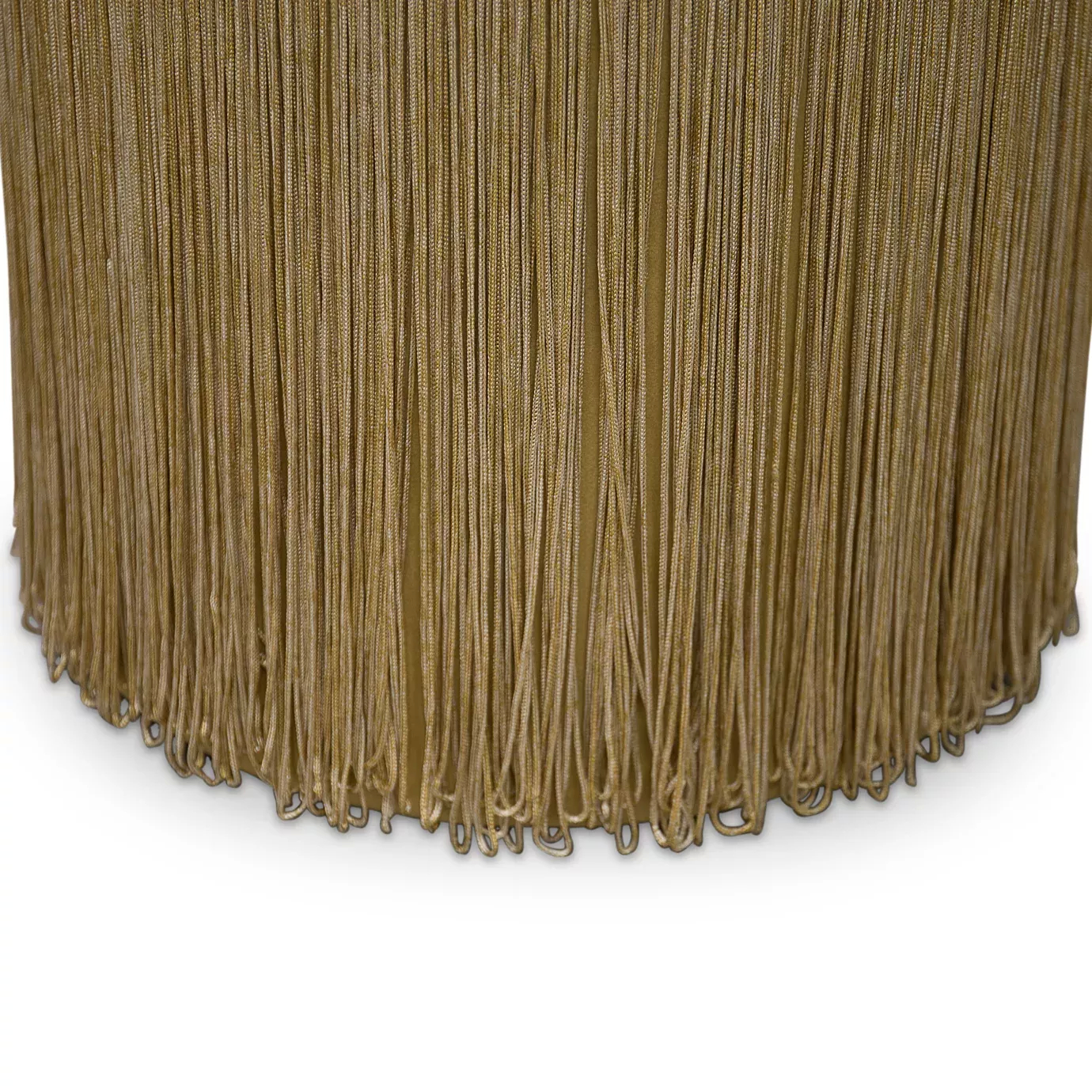 Elegant close-up of the long fringes detail in beige and golden tones of the Isabella Stool's base.