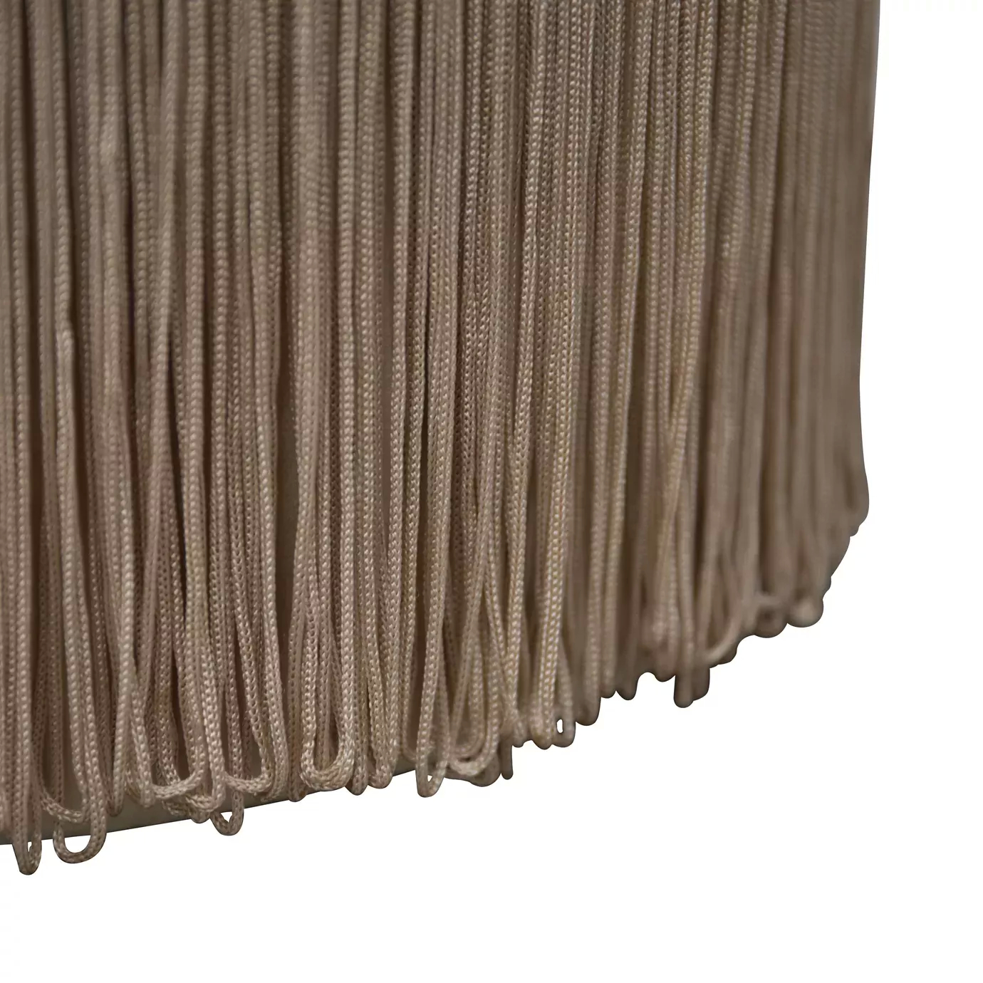 Elegant close-up of the long fringes detail in a light tone of the Sophia Stool's base.