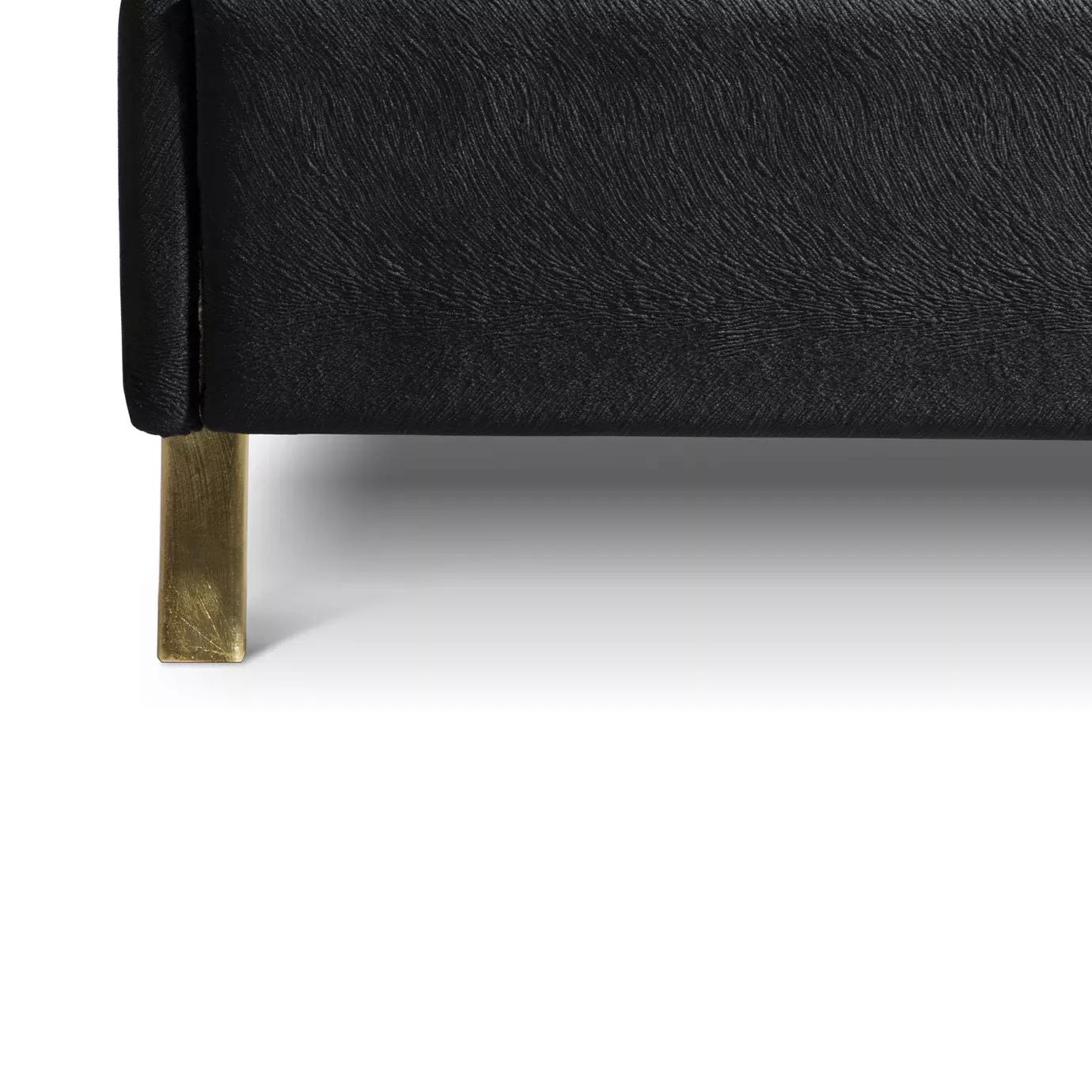 Elegant close-up of the black velvet upholstery detail and golden foot of the Alexia Bed.
