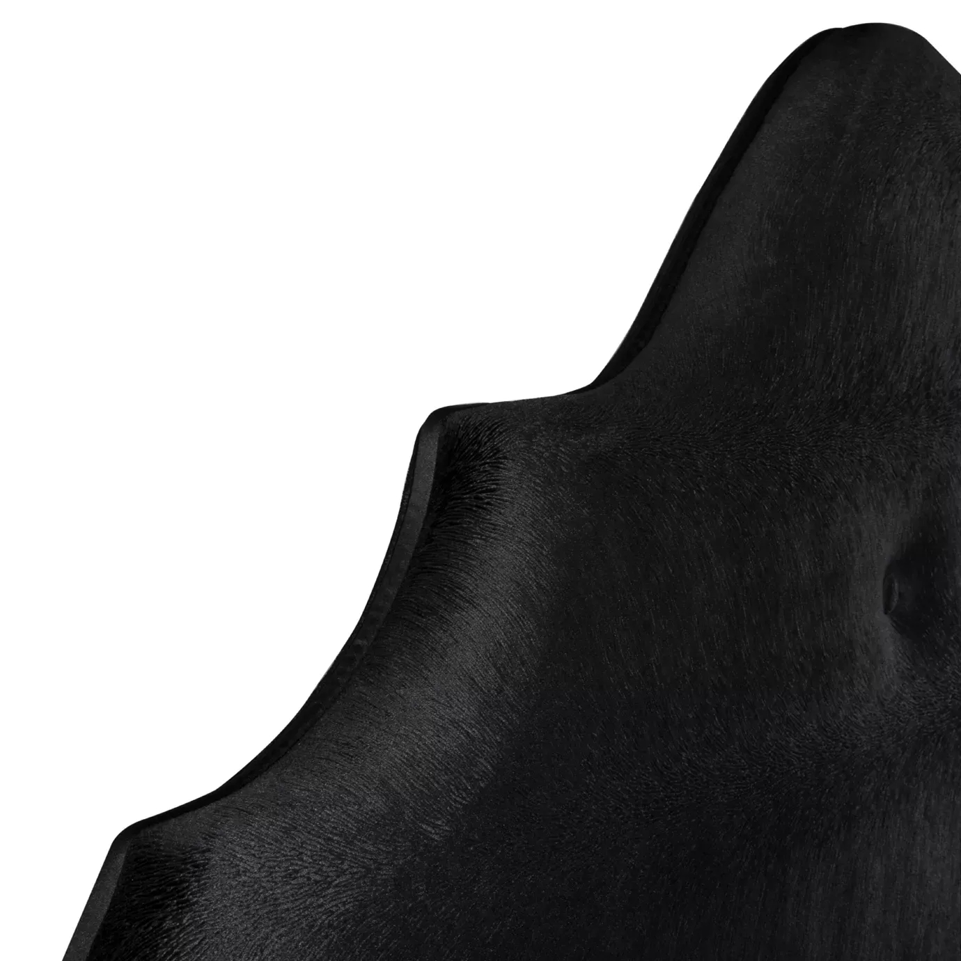 Elegant close-up of the black velvet upholstery detail of the Alexia Bed's headboard with a curved design.