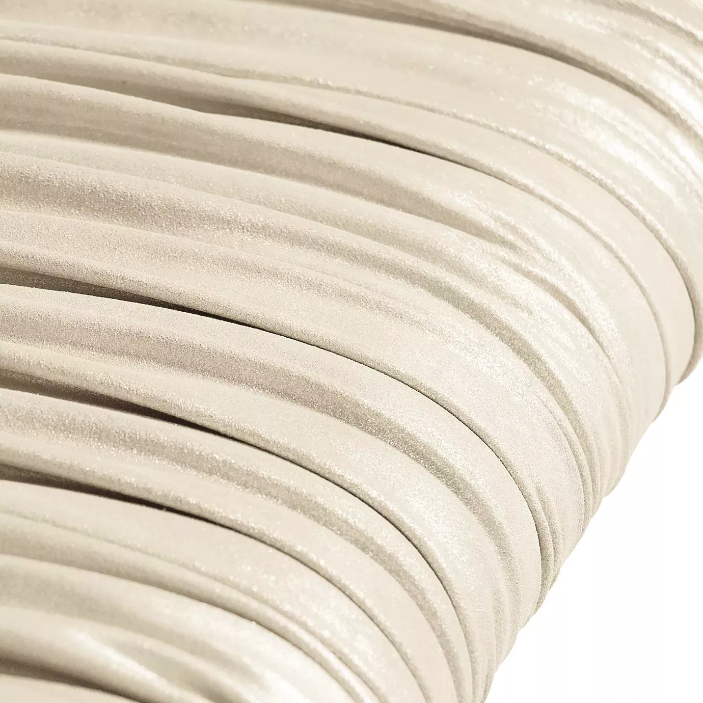 Elegant close-up of the pleated light textured fabric upholstery detail of the Plissé Bed's base.