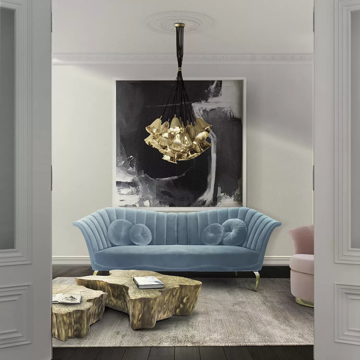 Elegant living room with the two-seater sofa in light blue velvet, Wave Center Tables in golden tones, and the Gia Chandelier above them.