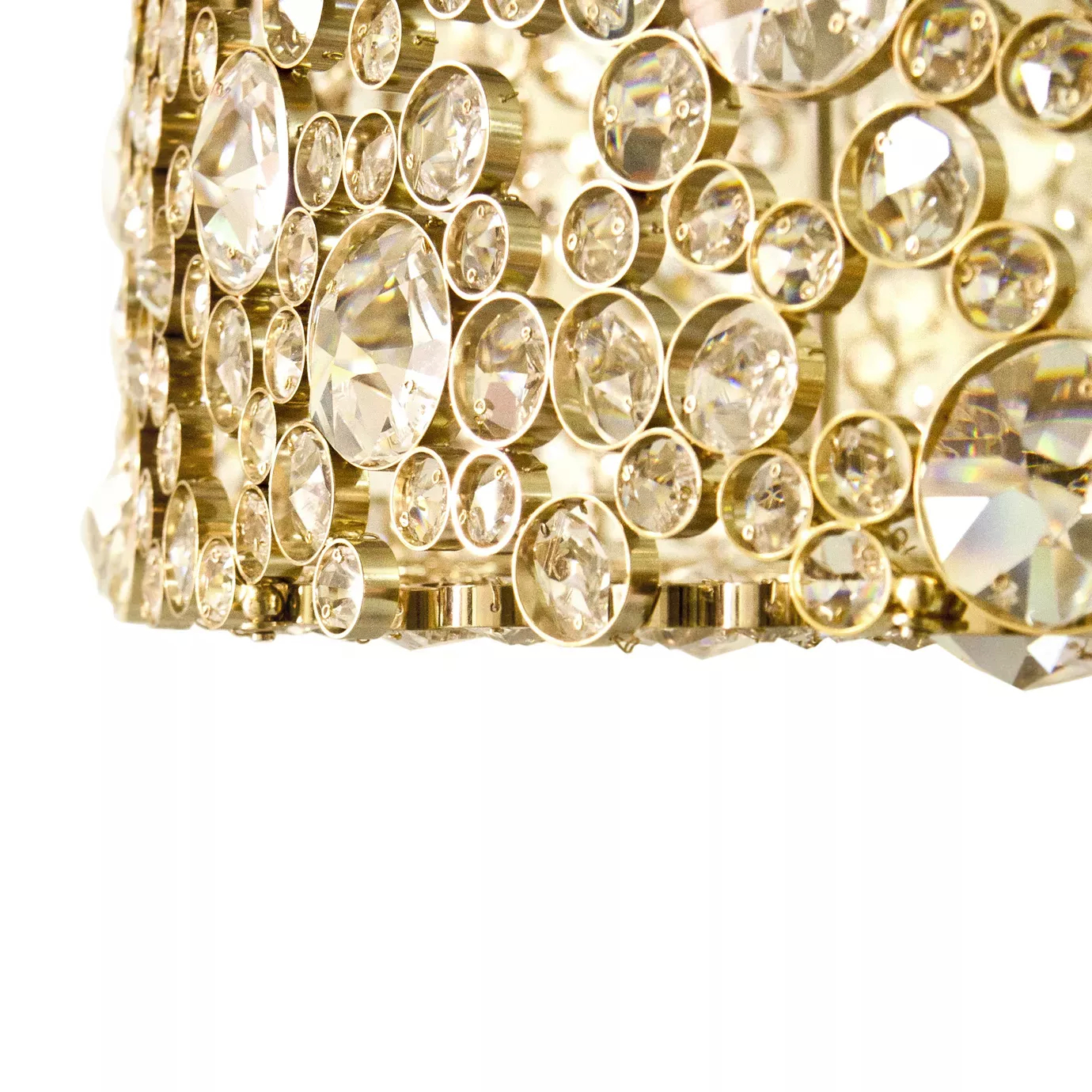 Elegant close-up of the detail of crystals of different sizes set in the golden frame of the Eternity Chandelier.