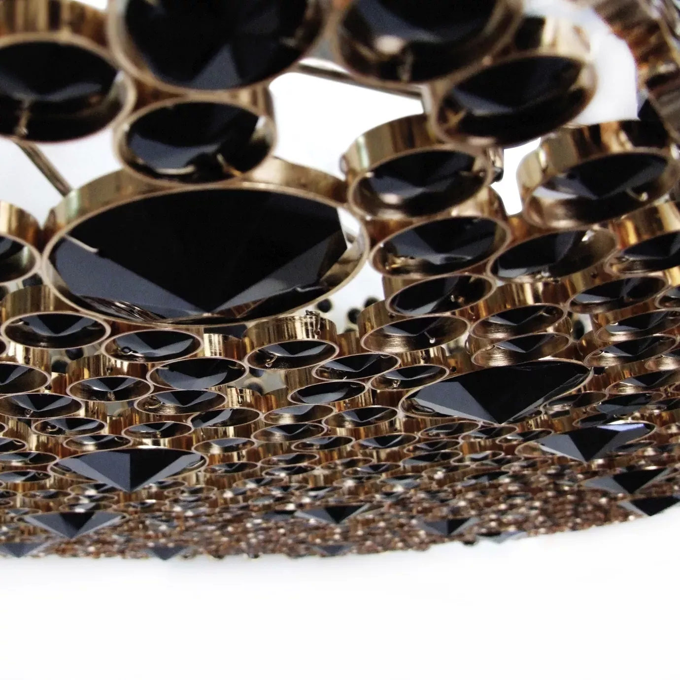 Elegant close-up of the golden frame detail studded with various black glass crystals of the Eternity Oval Black Glass Chandelier.