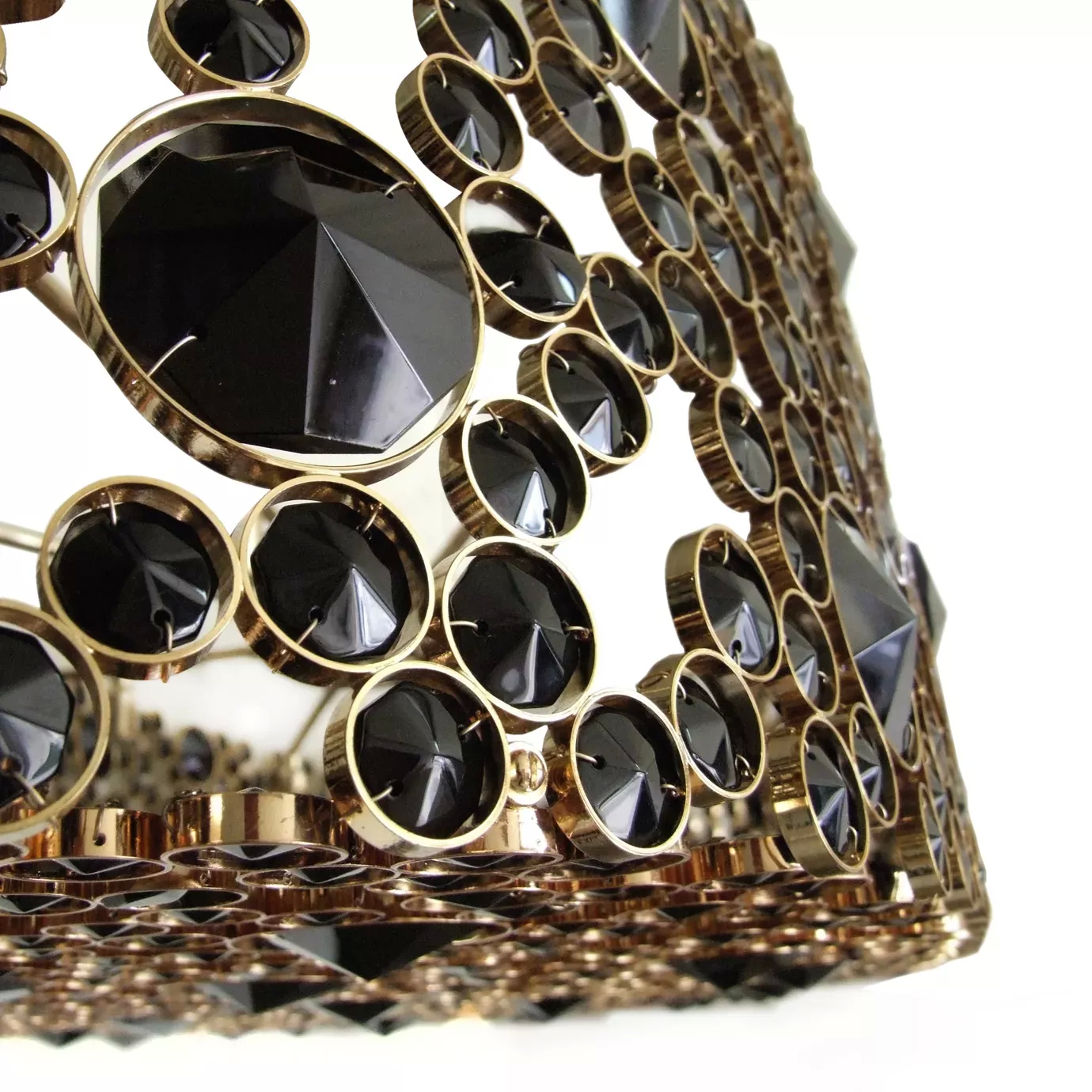 Elegant close-up of the golden frame detail studded with various black glass crystals of the Eternity Oval Black Glass Chandelier.