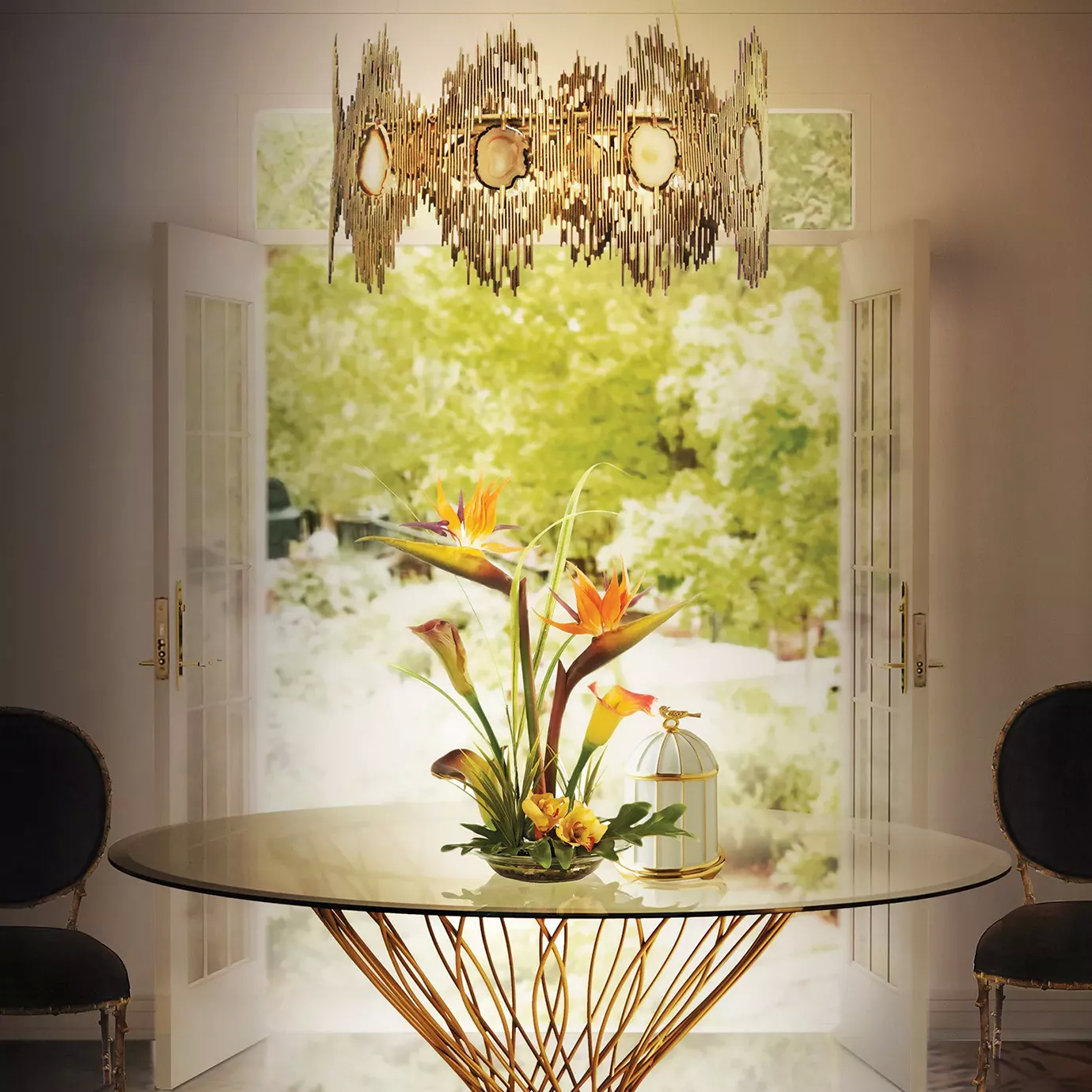 Elegant dining room with the Dining Table featuring a round glass top and a sculptural golden base, dark chairs with golden accents, and the Vivre Chandelier suspended above the table.