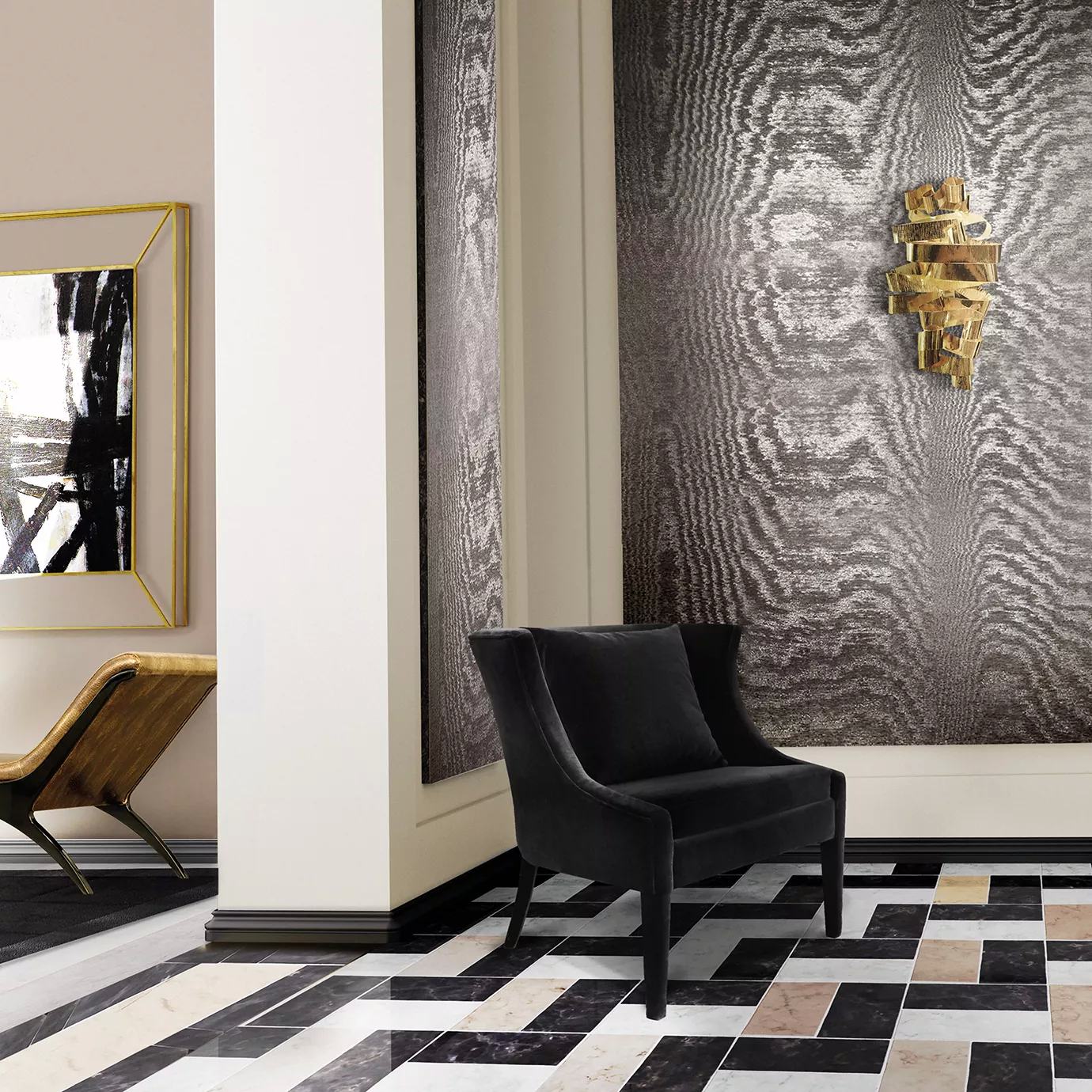 Elegant entryway with an armchair upholstered in black velvet with a cushion, a sculptural golden Chloe Sconce on the wall with grey-toned textured wallpaper, and a floor with a geometric pattern in shades of black, white, and beige.
