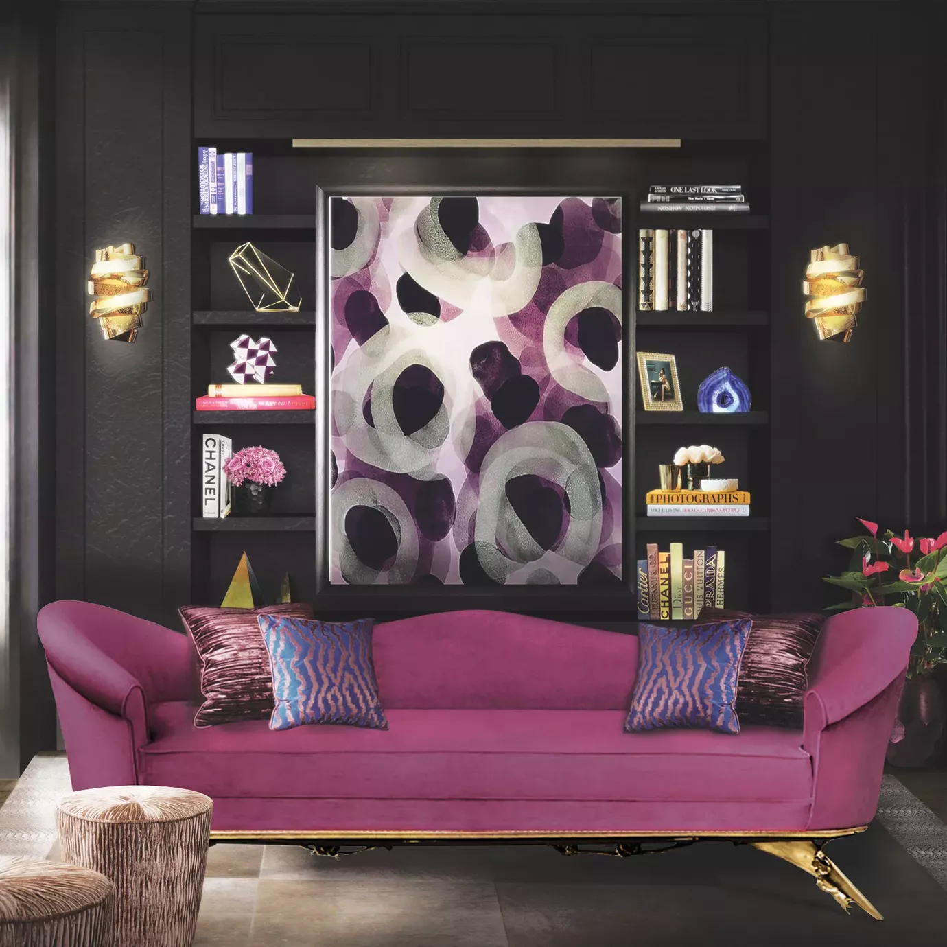 Elegant living room with a curved pink velvet sofa with patterned pillows, two sculptural golden Chloe Sconces on the dark walls flanking an abstract painting, and a dark bookcase filled with books and decorative objects.