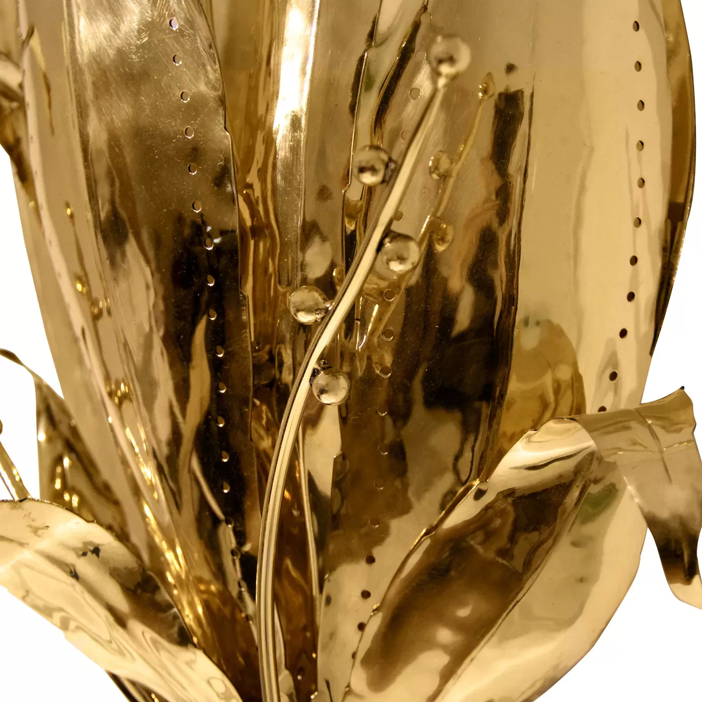 Elegant close-up of the leaf details and small spherical accents along the golden stems of the Botanica Sconce.