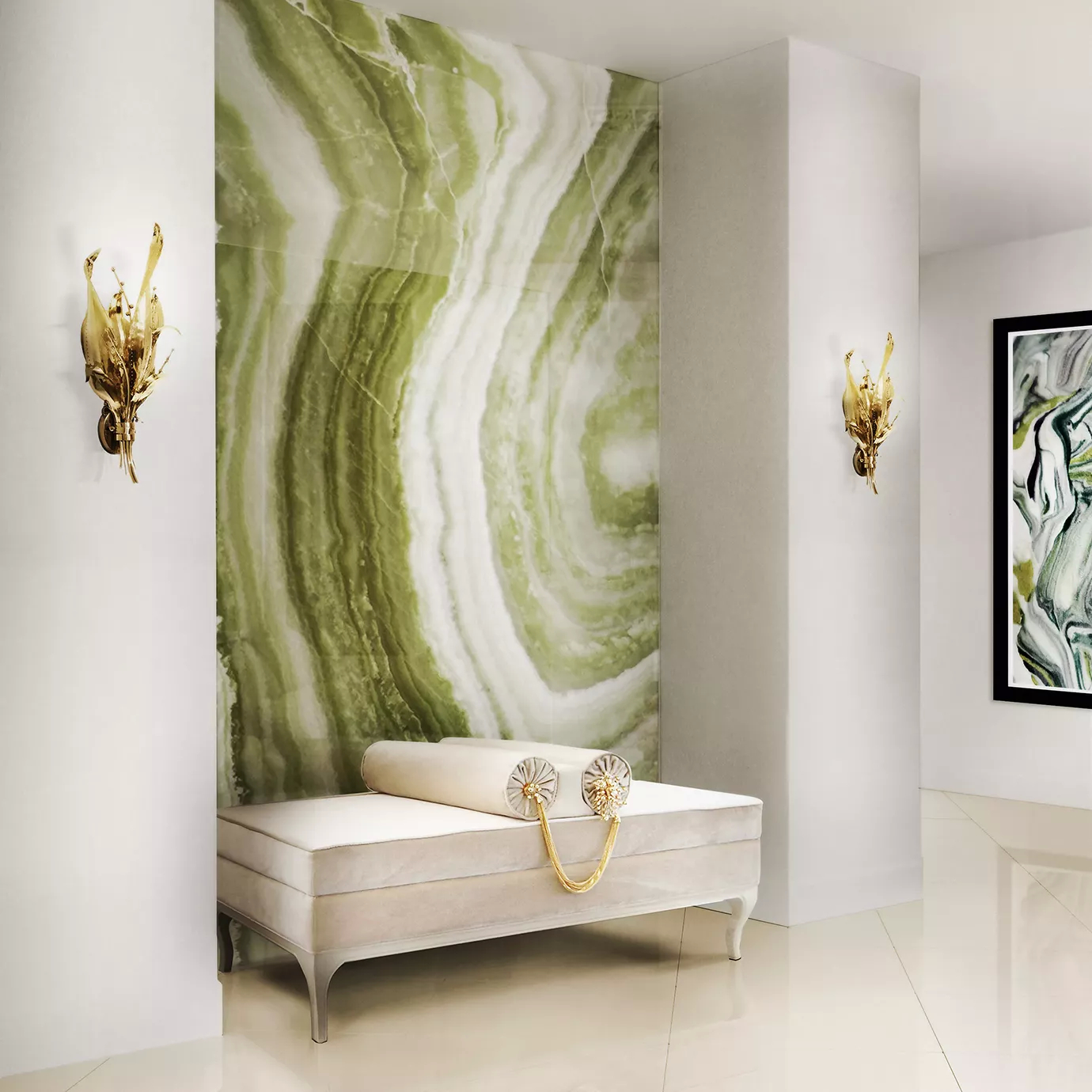 Elegant entryway with a light-toned upholstered bench featuring a cylindrical pillow and golden details, flanked by two sculptural golden Botanica Sconces mounted on white walls adjacent to a green and white onyx wall panel.