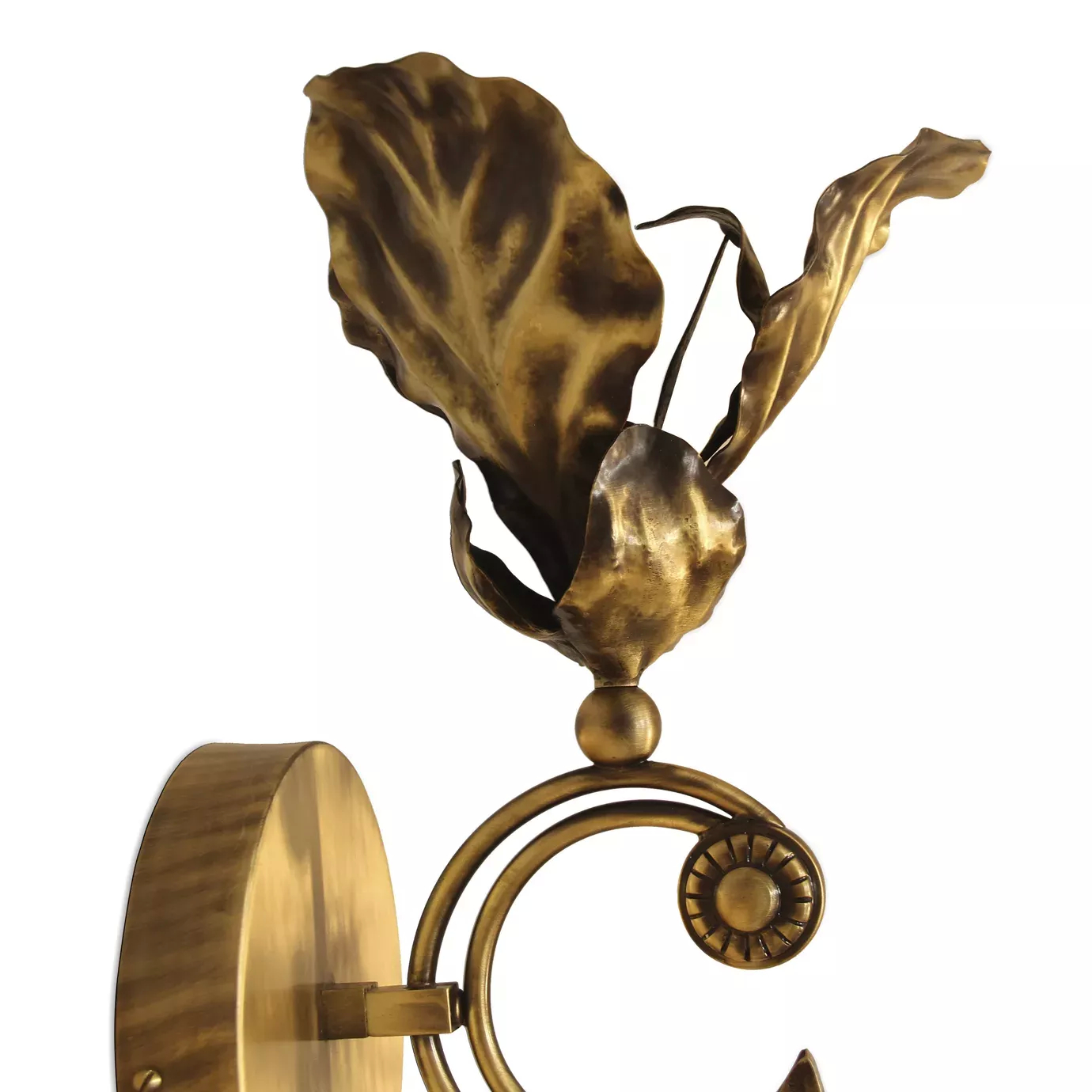 Elegant close-up of the textured leaf details and the spiral decorative element of the golden Flora Sconce.