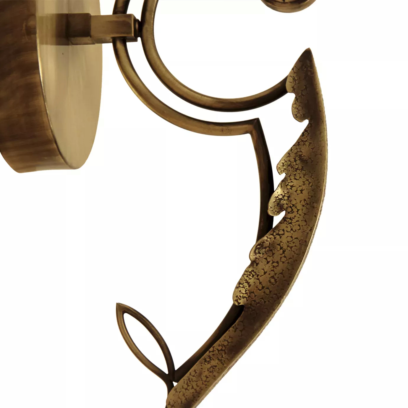 Elegant close-up of the sinuous stem detail with a textured leaf of the golden Flora Sconce.