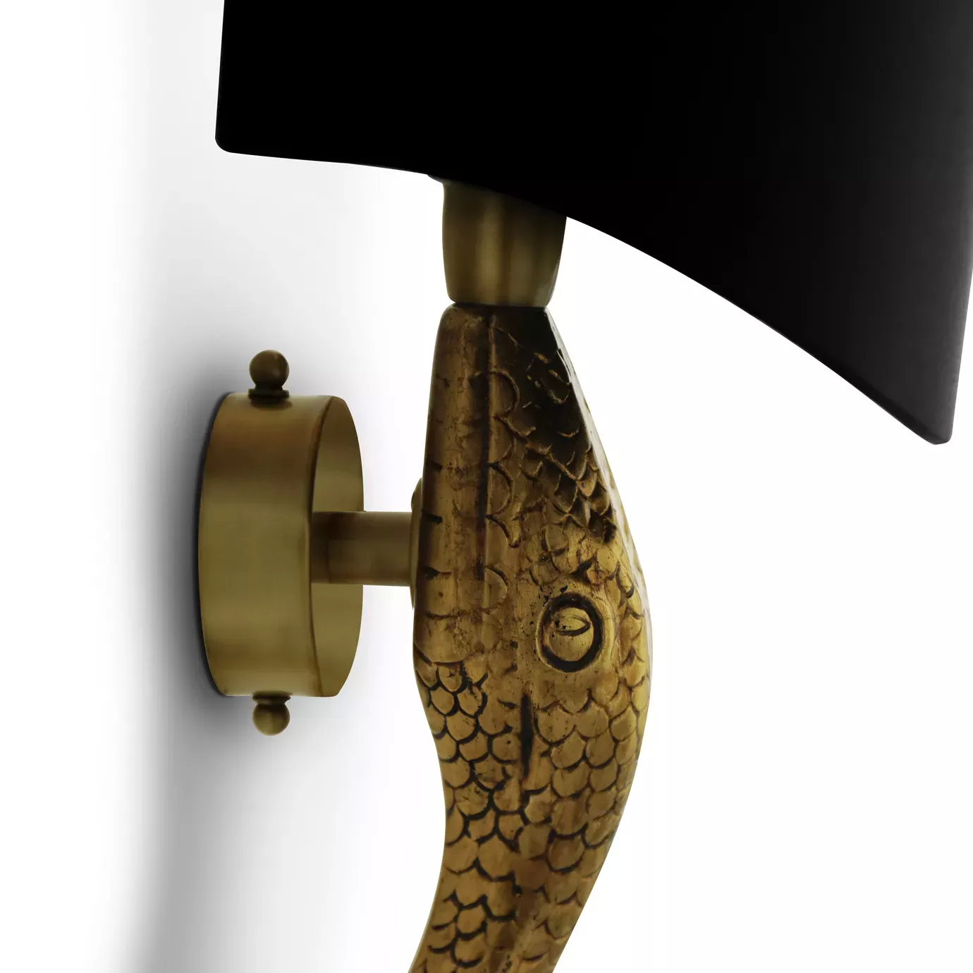 Elegant close-up of the textured golden serpent head detail holding the base of the black lampshade of the Serpentine Sconce.