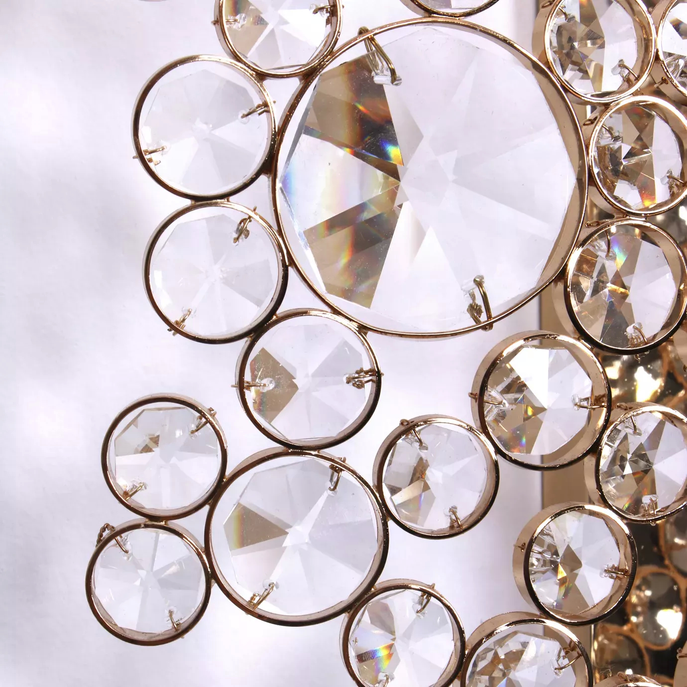Elegant close-up of the detail of the faceted clear crystals of varying sizes with golden edges of the Eternity Sculpture.