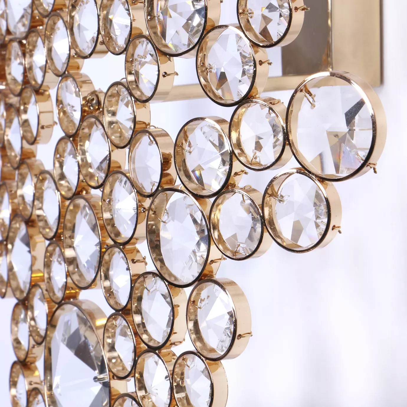 Elegant close-up of the detail of the faceted clear crystals of varying sizes with golden edges of the Eternity Sculpture.