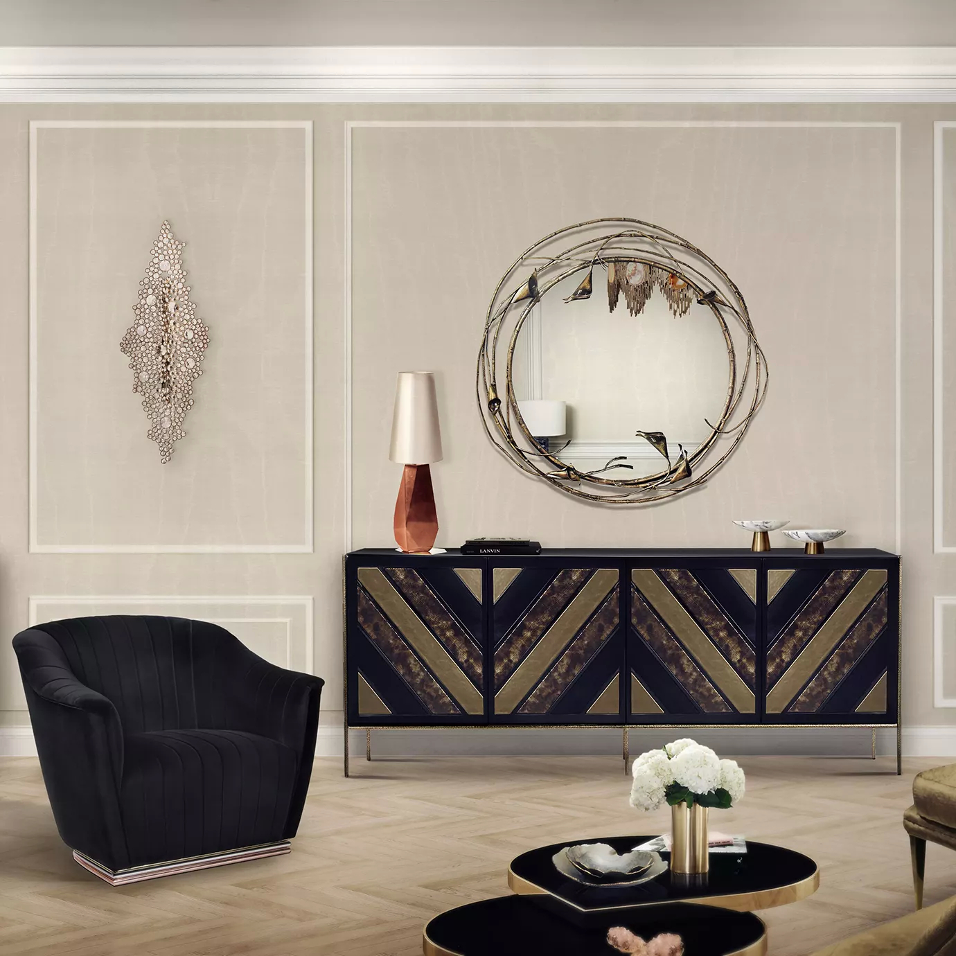 Elegant living room with a armchair upholstered in black velvet, a black and gold sideboard with a geometric copper-toned table lamp, a round mirror with sculptural details, and the golden and shiny Eternity Sculpture mounted on the light wall.