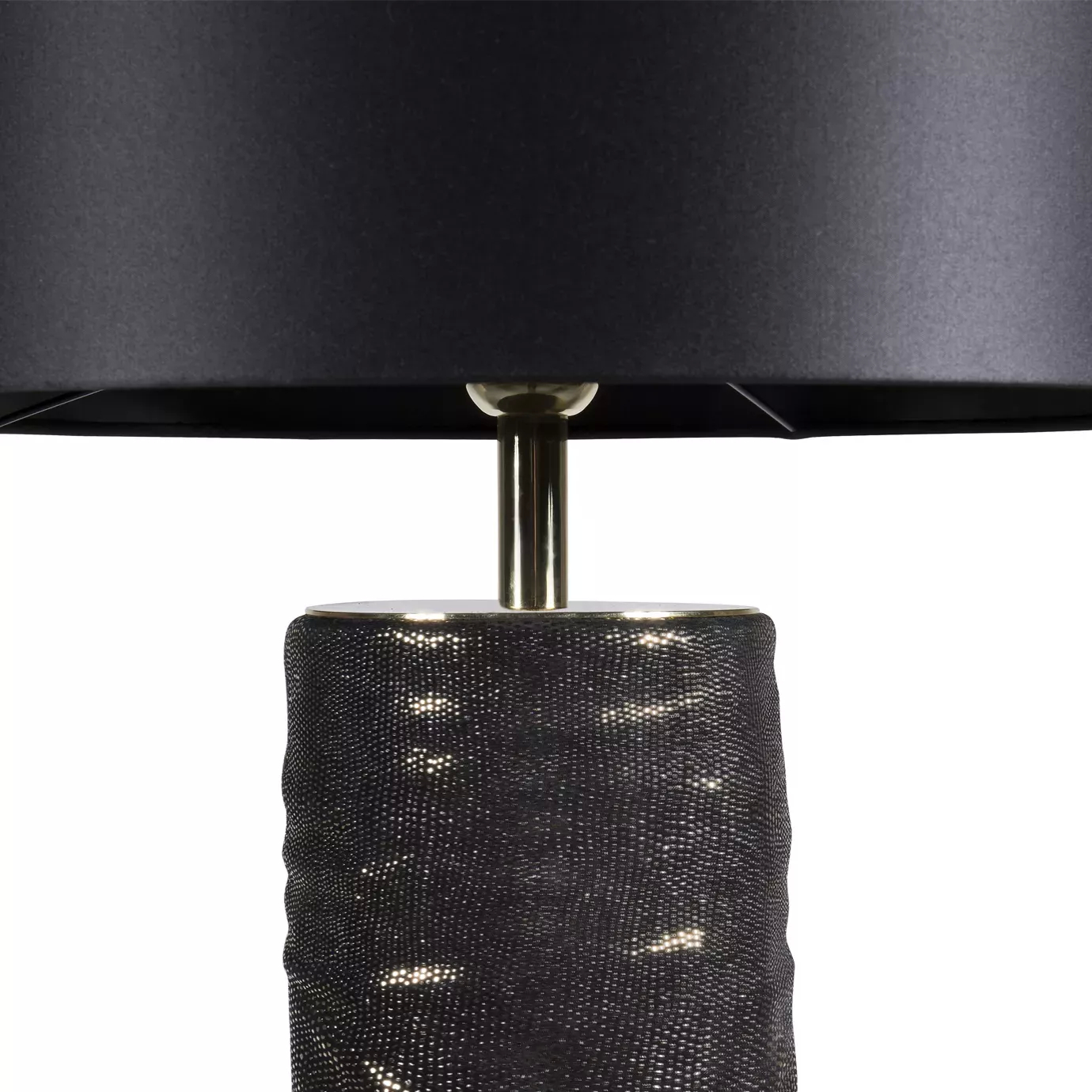 Elegant close-up of the top detail of the textured brown and gold-toned base and the golden rod supporting the black lampshade of the Ruchê Table Lamp.