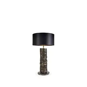 Elegant Ruchê Table Lamp with a textured sculptural base in shades of brown and gold, and a black lampshade.