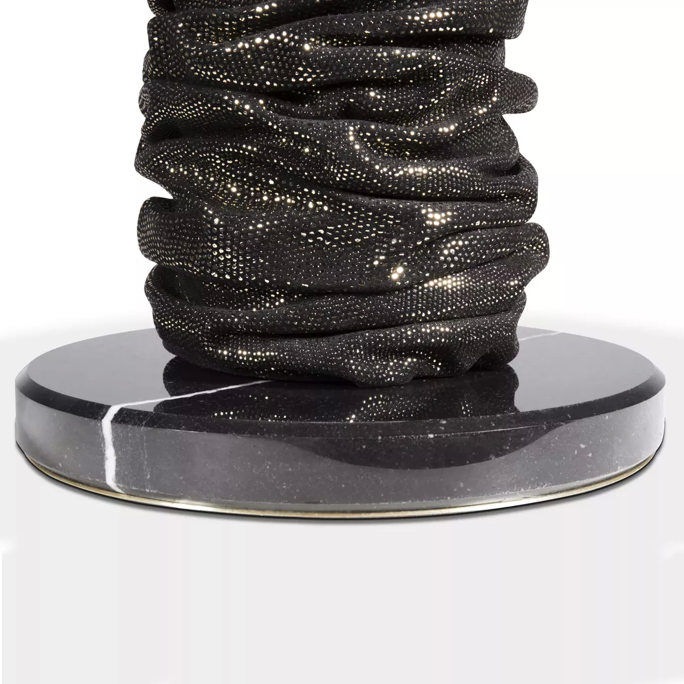 Elegant close-up of the round black marble base detail with a golden rim and the textured brown and gold-toned bottom of the Ruchê Table Lamp.