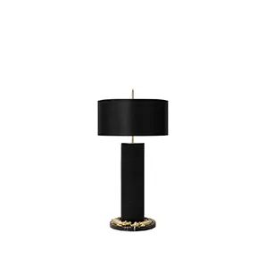 Elegant Reptilian Table Lamp with a textured black cylindrical base featuring sculptural golden details at the bottom and top, and a black lampshade.