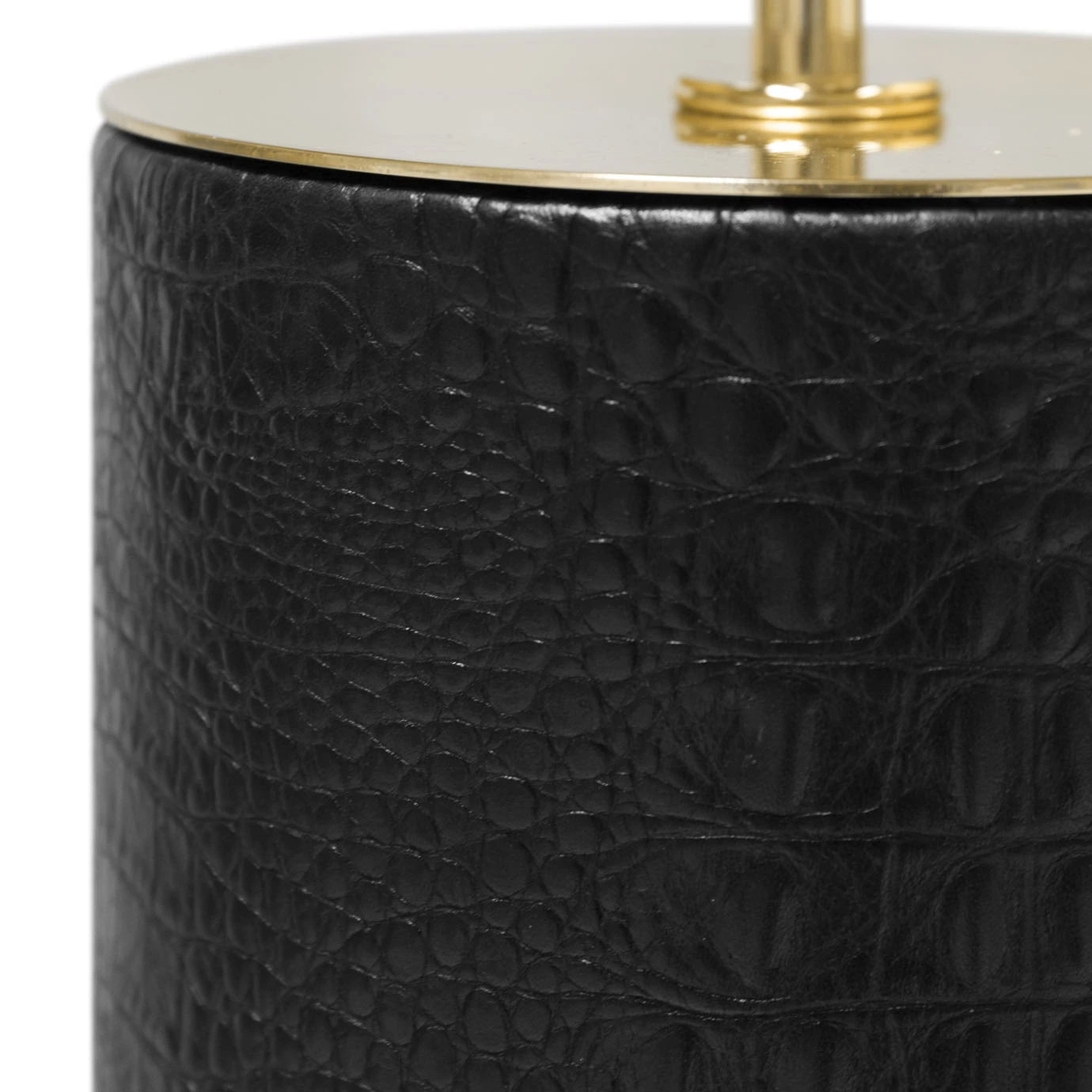 Elegant close-up of the textured black crocodile-skin imitation detail and the golden disc at the top of the cylindrical base of the Reptilian Table Lamp.
