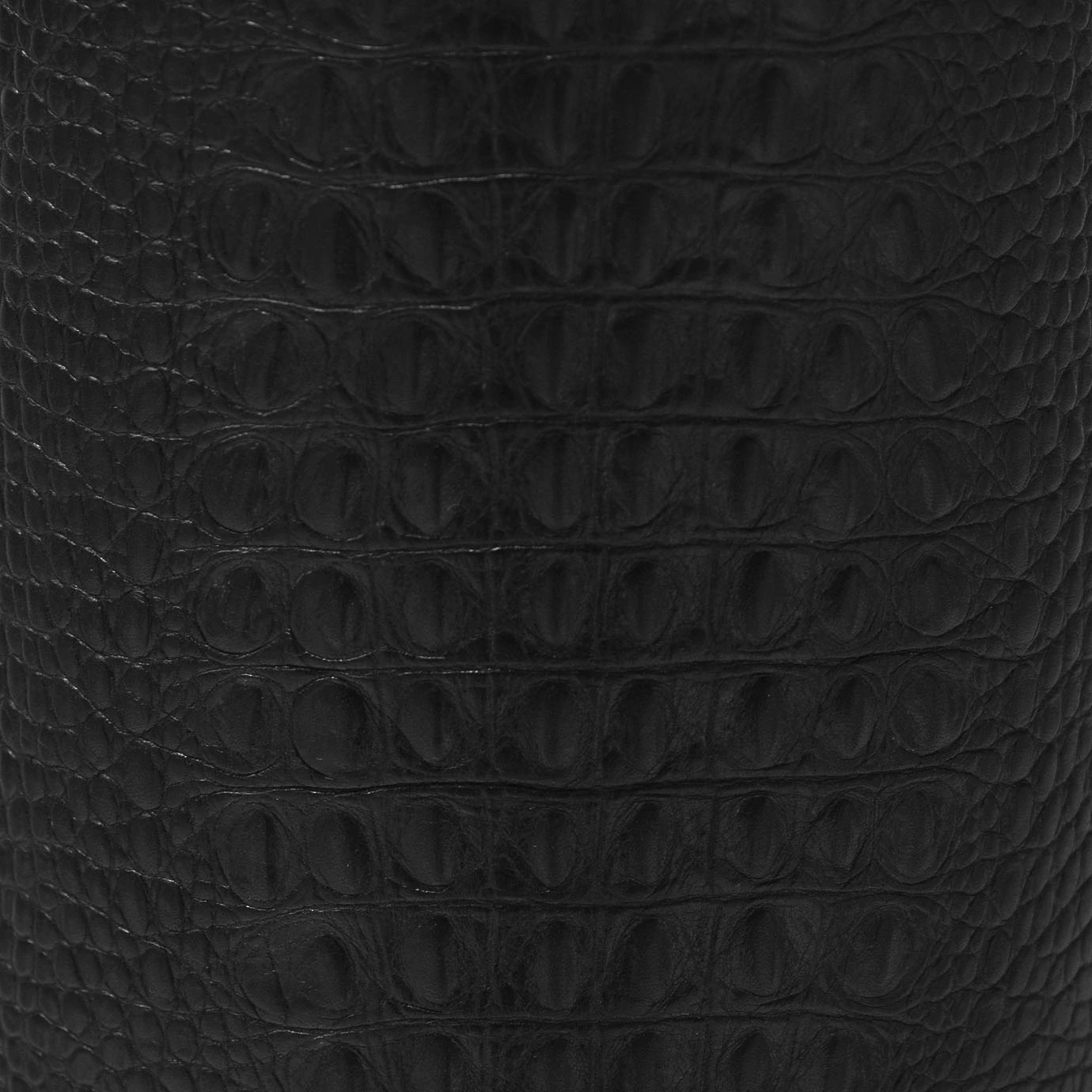 Elegant close-up of the textured black crocodile-skin imitation of the cylindrical base of the Reptilian Table Lamp.