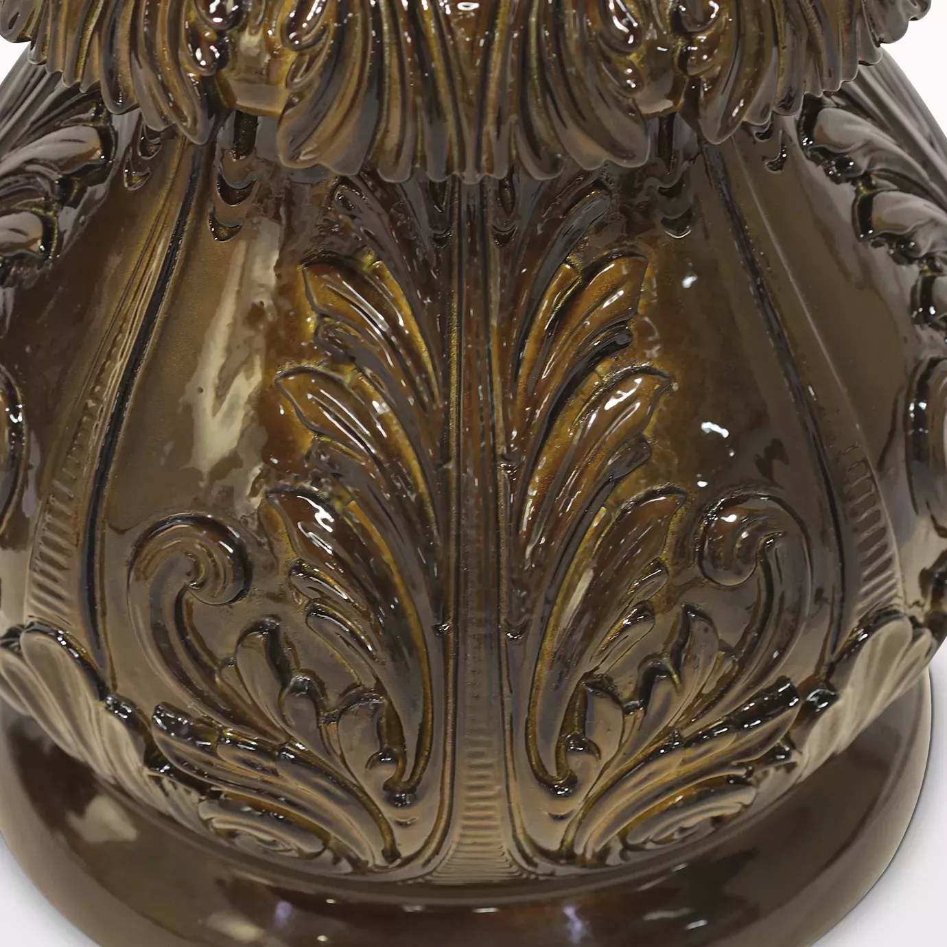 Elegant close-up of the rich and glossy floral carving detail on the brown-toned base of the Lotus Floor Lamp.