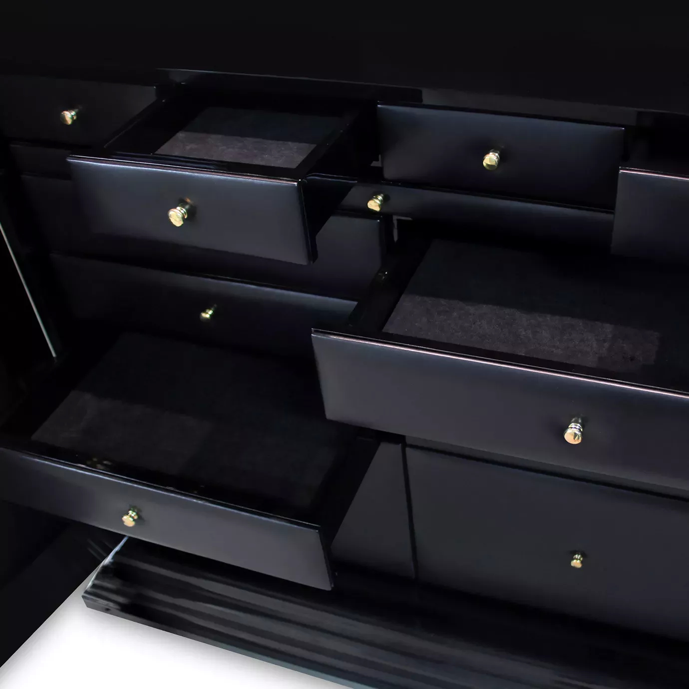Detail view off Interior of luxury Parisian armoire with elegant black drawers and gold accents