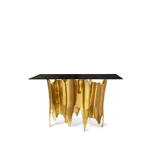 Elegant Obssedia Console with black glass top and sculptural golden base.