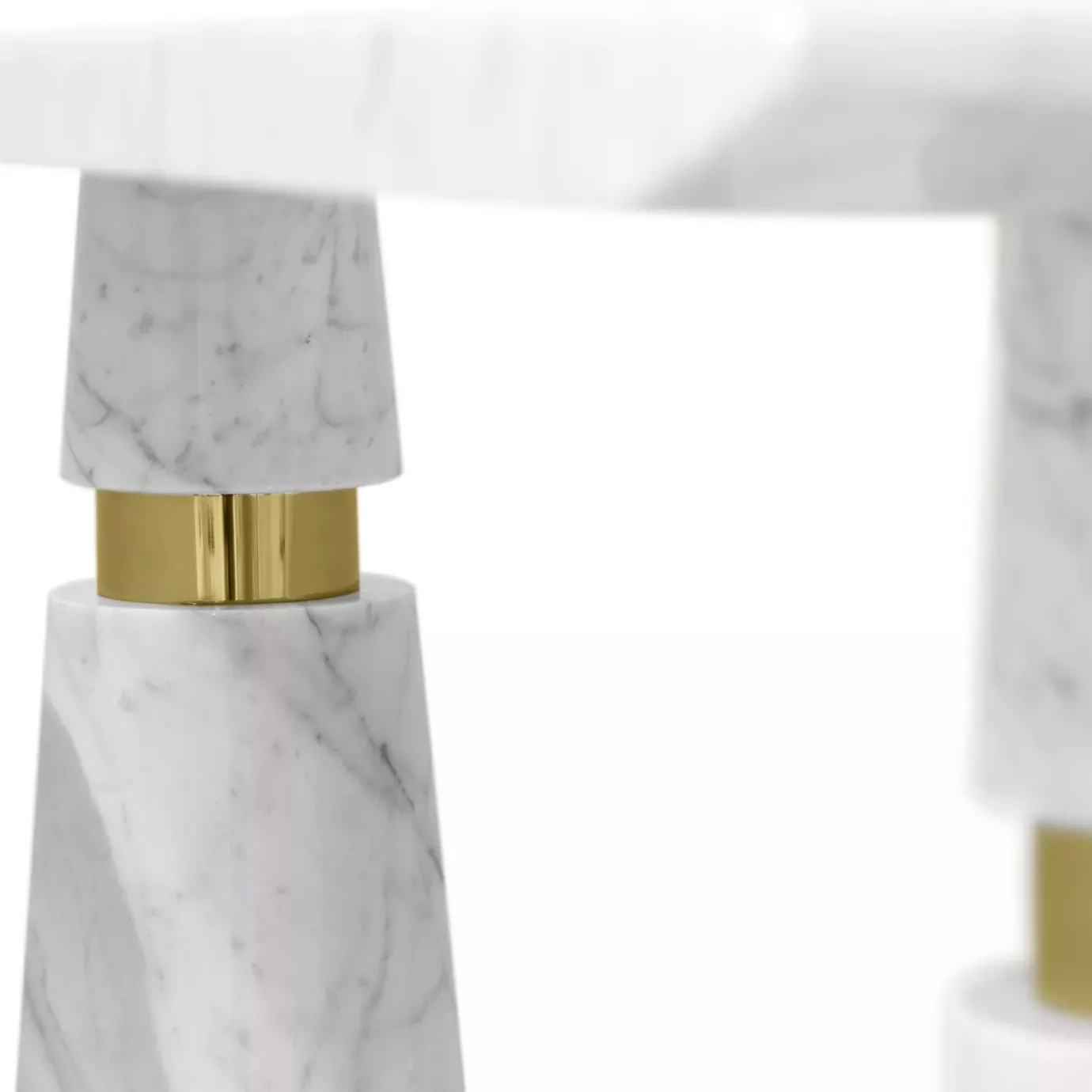 Elegant close-up of the Carrara marble base with golden detail of the Avalanche Console.