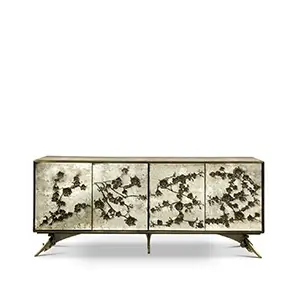 The Spellbound Aged Mirror Cabinet features an elegant golden frame and golden flower-shaped details on its four front doors.