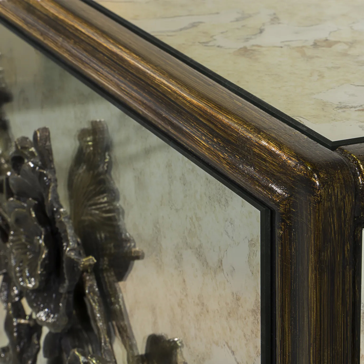 Spellbound Aged Mirror Cabinet: Close view on the Aged Gold Leaf finish of the cabinet’s frame, contrasting with the light colors of the aged mirror structure.