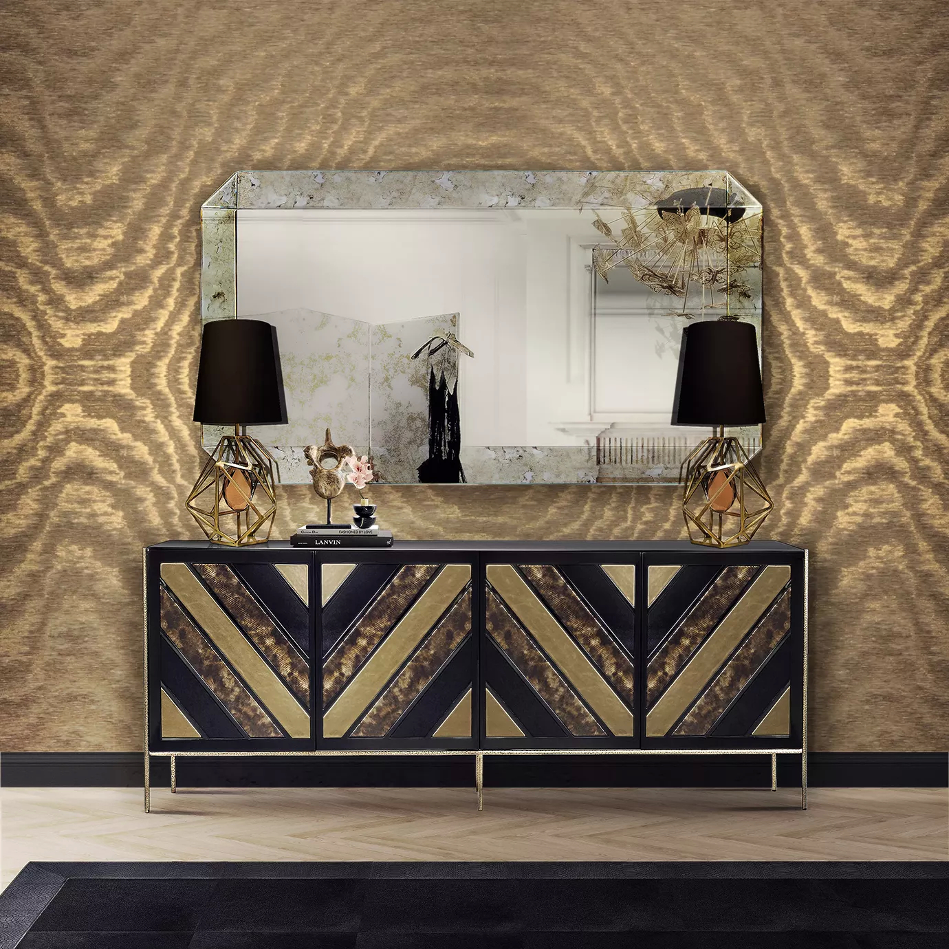 Elegant living area with the black and gold Nazca sideboard with four doors, topped by the Tamara Rectangular Mirror with a textured white and grey-toned frame, and flanked by two Gem Table Lamps with geometric golden bases and black lampshades, on a light wooden floor and against a brown and gold-toned patterned wallpaper.