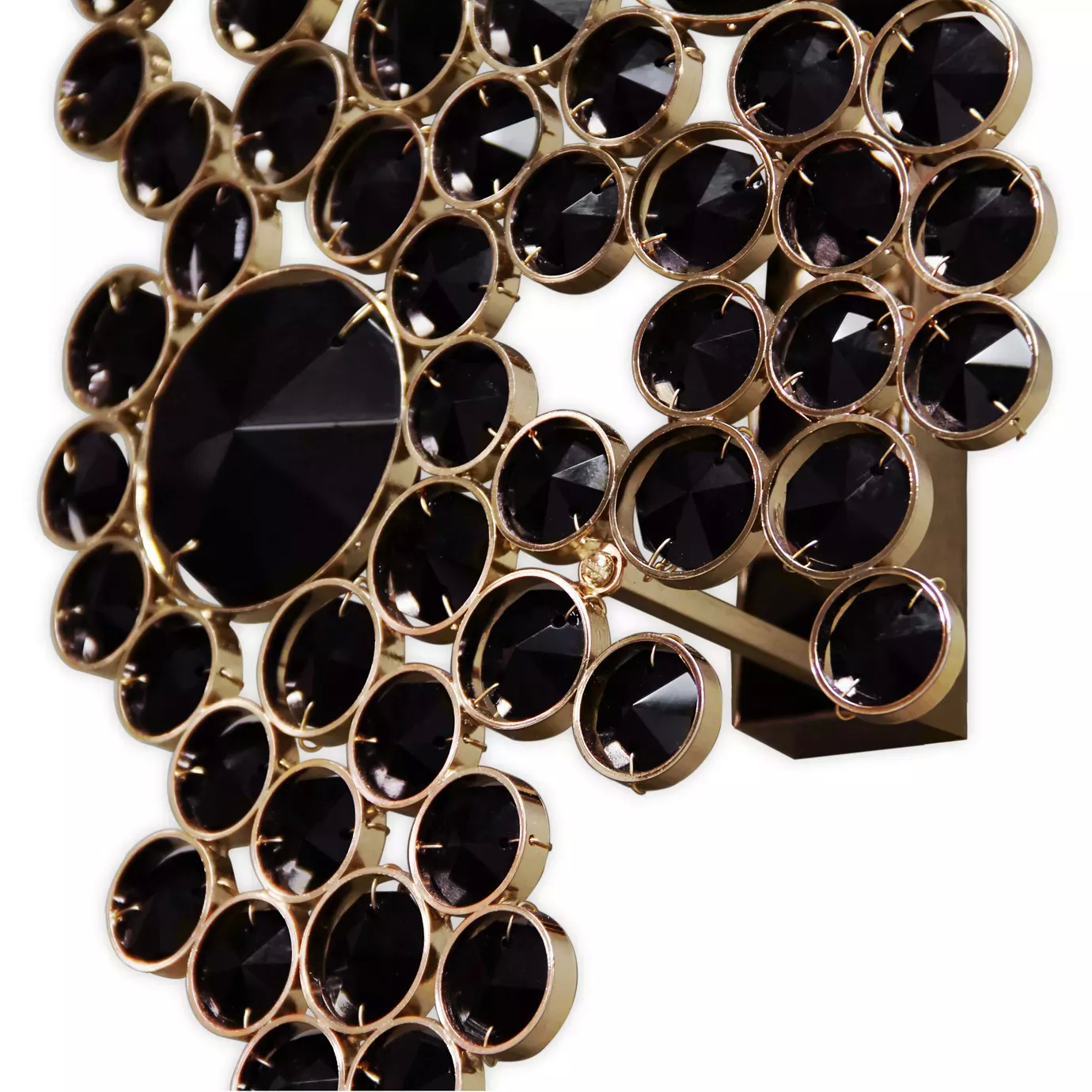 Elegant close-up of an Eternity Sconce detail featuring faceted black glass pieces of varying sizes interconnected by a golden metallic structure.