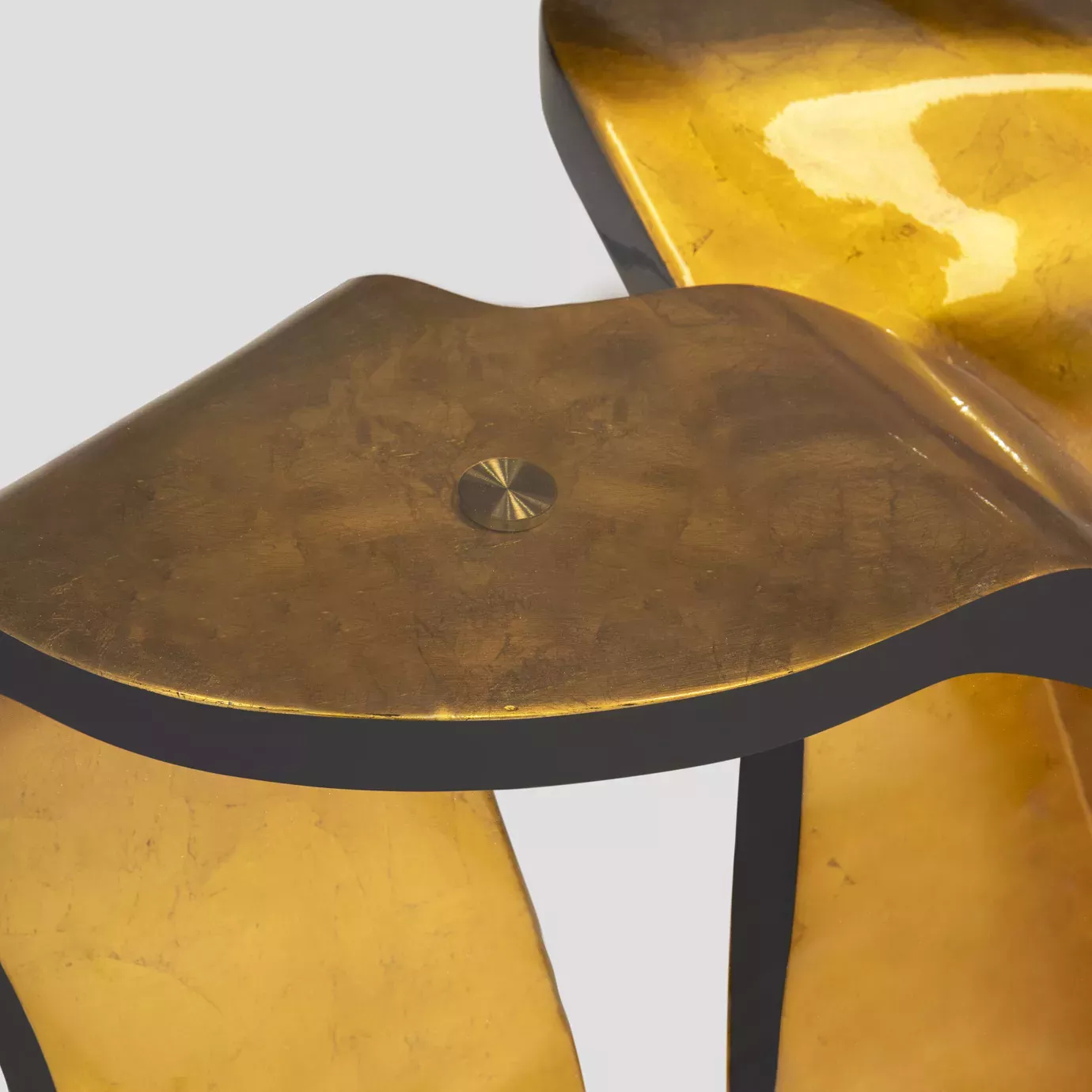Elegant close-up of the golden base detail of the Ribbon Broken Gold Leaf Dining Table.