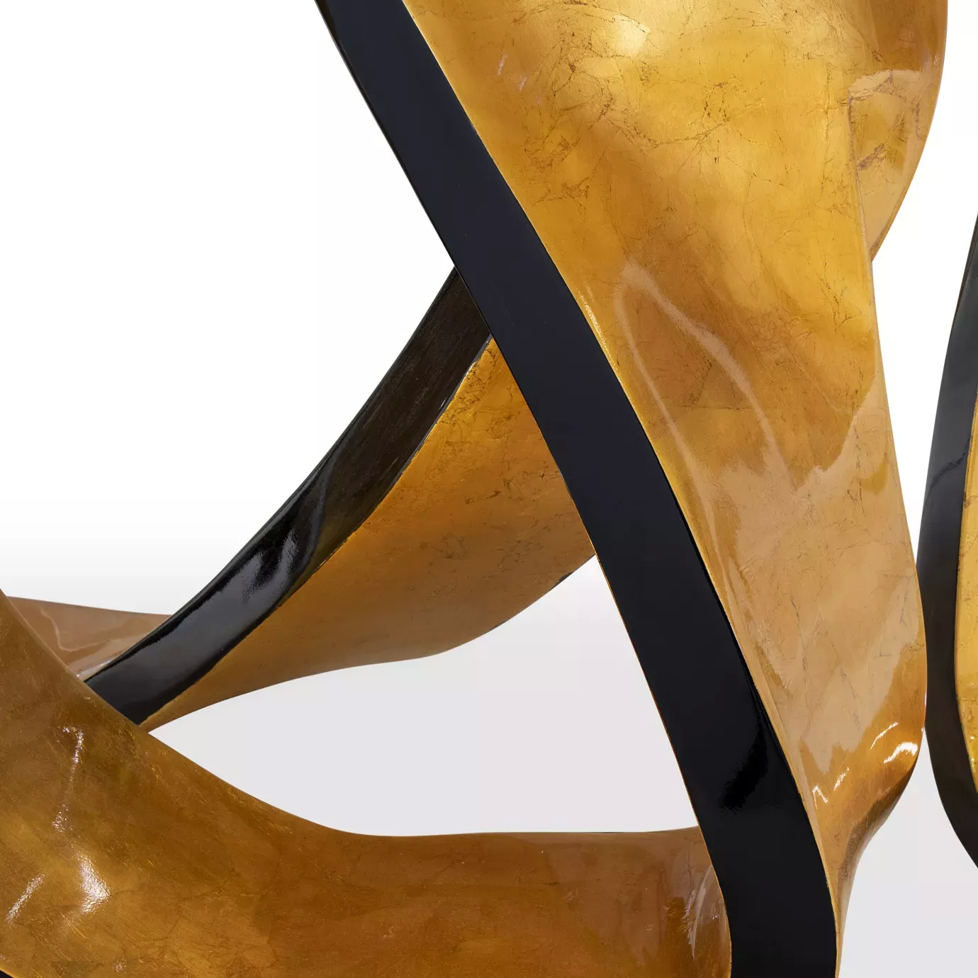 Abstract close-up of the golden and black base of the Ribbon Broken Gold Leaf Dining Table.