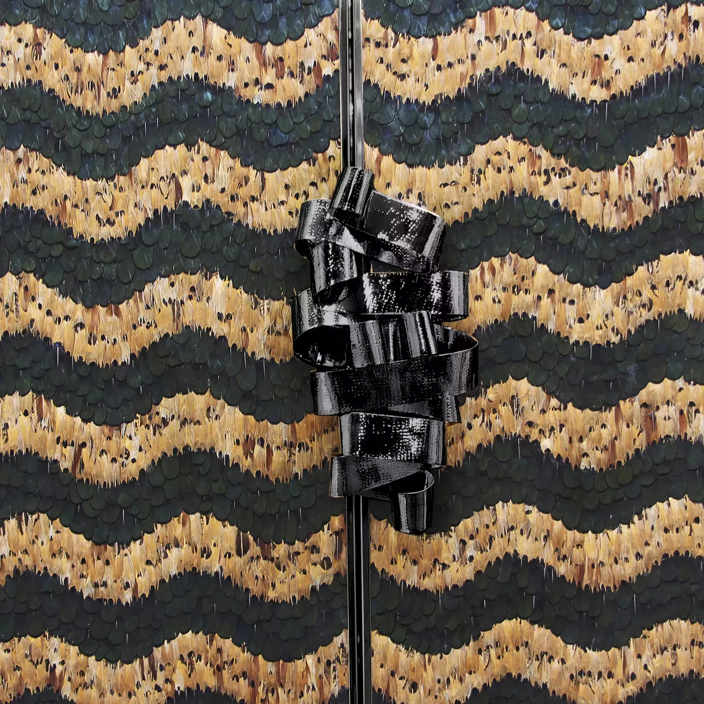 Close view of the Divine Peacock & Pheasant Caramel Feather Armoire front doors, showcasing the delicate caramel and dark green peacock and pheasant feather that cover the doors, as well as the black metal ribbon handle.