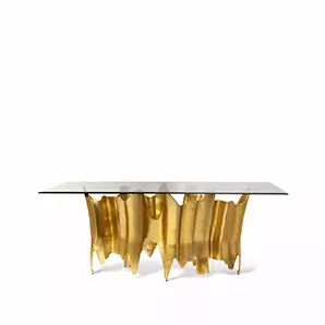 Elegant Obssedia Dining Table with glass top and sculptural golden base.