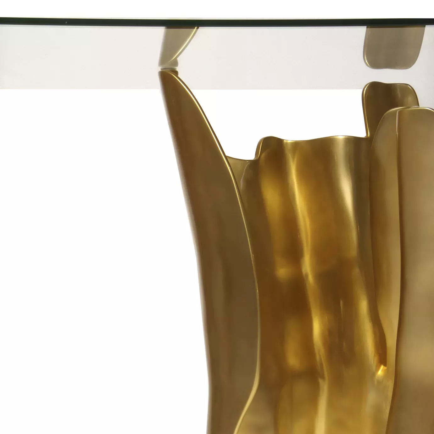 Elegant close-up of the joint between the glass top and sculptural golden base of the Obssedia Dining Table.