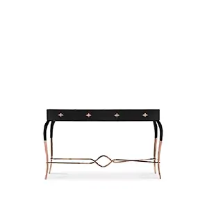 Elegant Luridae Console with a long black tabletop featuring four drawers adorned with decorative copper-toned handles, and a frame with curved black and copper legs with a sculptural copper detail at the base.