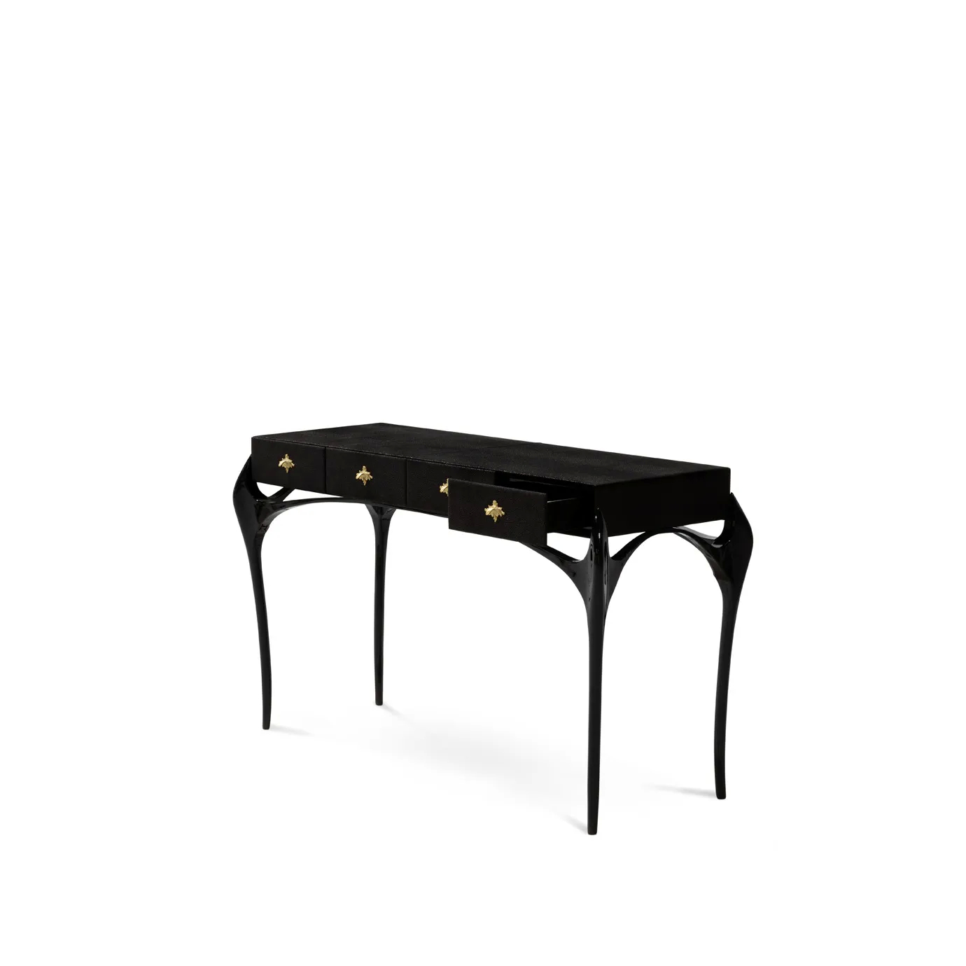 Elegant Temptation Console with a long black tabletop featuring four drawers, one of which is fully open, adorned with decorative golden star-shaped handles, and a frame with curved black legs and a sculptural golden detail at the base, viewed from a side angle.