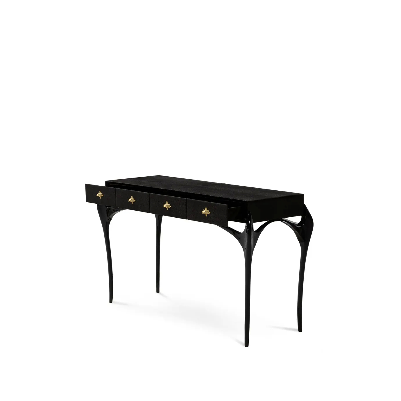 Elegant Temptation Console with a long black tabletop featuring four drawers, two of which are open, adorned with decorative golden star-shaped handles, and a frame with curved black legs and a sculptural golden detail at the base, viewed from a more pronounced side angle.