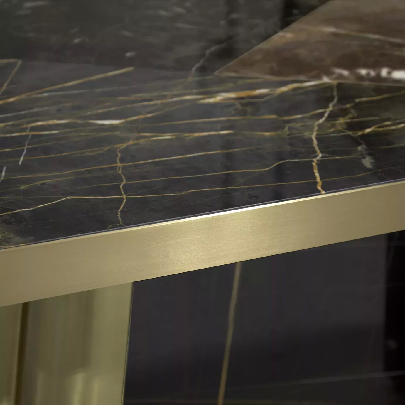 Elegant close-up of the golden edge and black and gold granite top of the Decodiva Dining Table.
