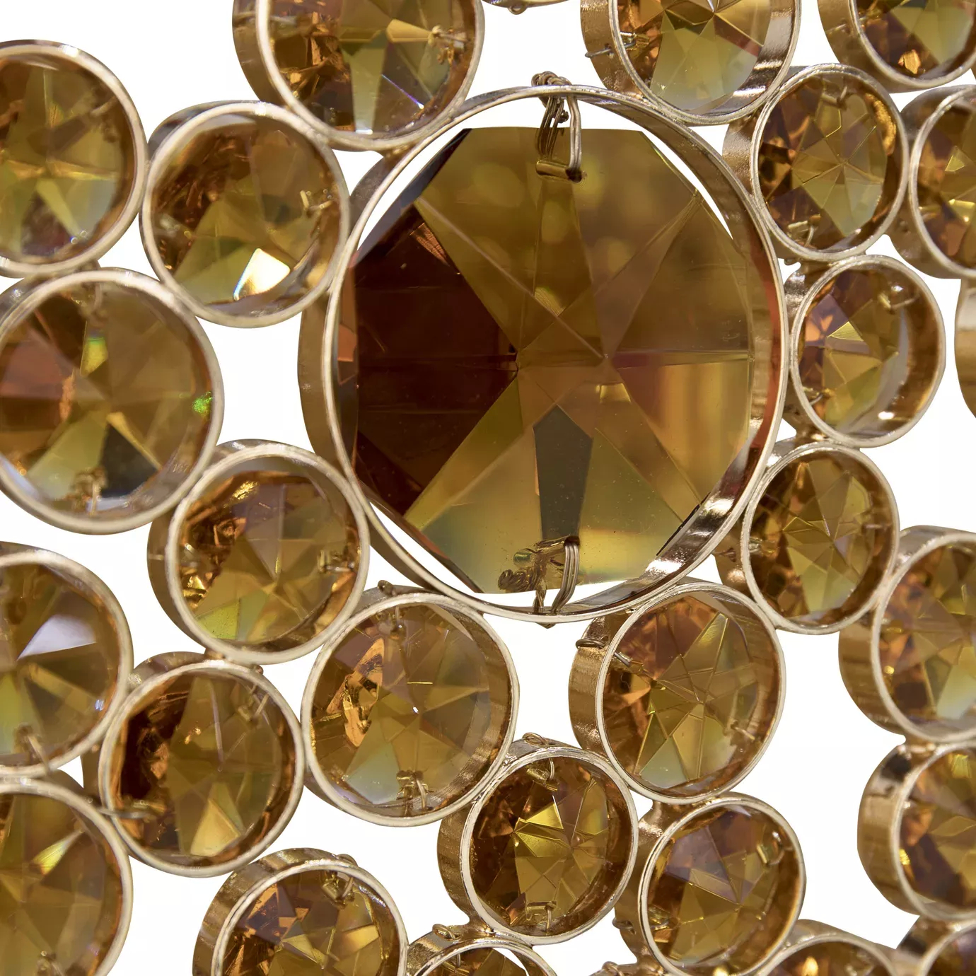 Elegant close-up detail of a large central faceted bronze glass detail surrounded by numerous smaller bronze glass details, all affixed to the bronze-toned frame of the Eternity Oval Chandelier.