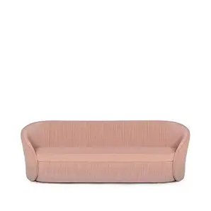 Elegant Bloom Sofa with a curved design and soft pink fabric upholstery featuring vertical pleated details on the backrest and base.